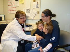 Photo of a medical professional with a parent and child