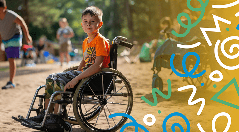 young boy in wheelchair at park