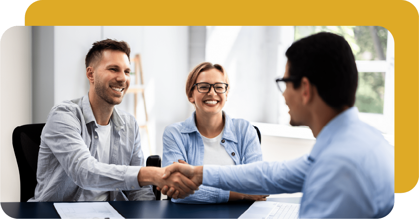 couple: man shaking with man across desk