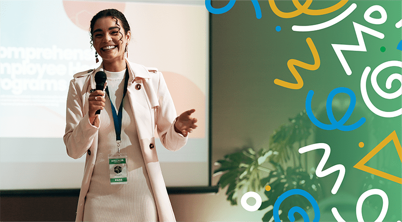 woman speaking at conference holding microphone