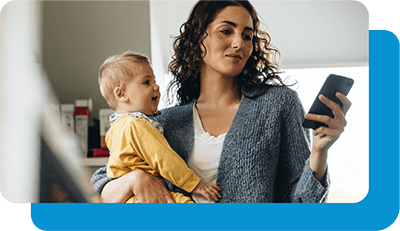 Mom holding child looking at phone