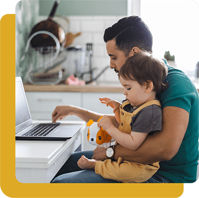 dad with boy on lap working on laptop