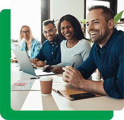 2 men and 2 women in a meeting smiling
