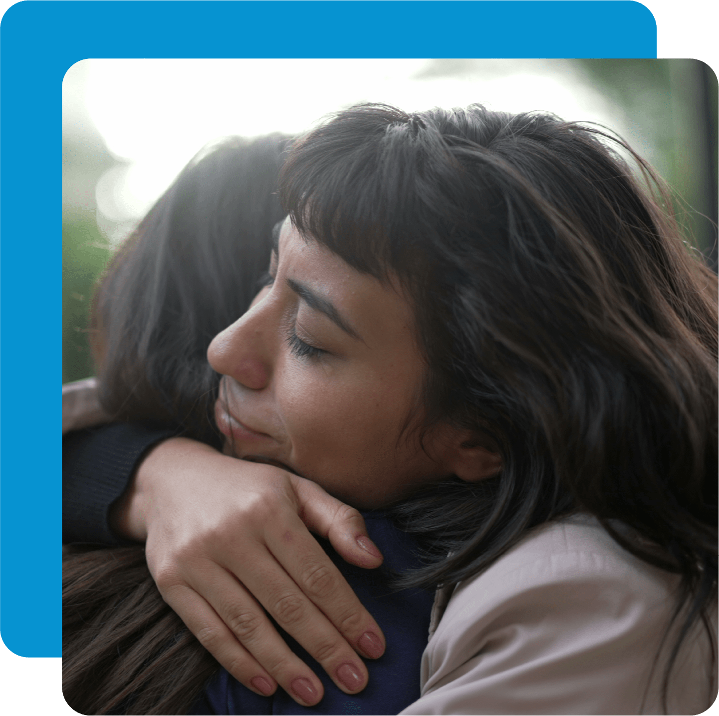 Woman hugging another woman