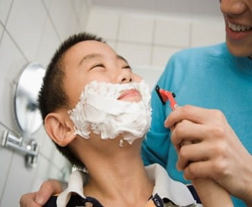 Father teaching son to shave
