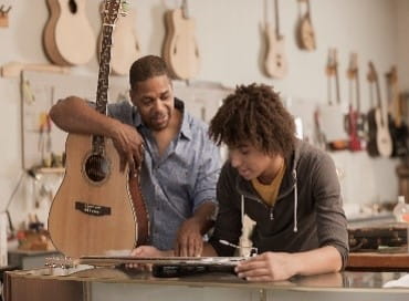 Father and son in music shop