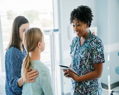 Nurse with patients in hospital