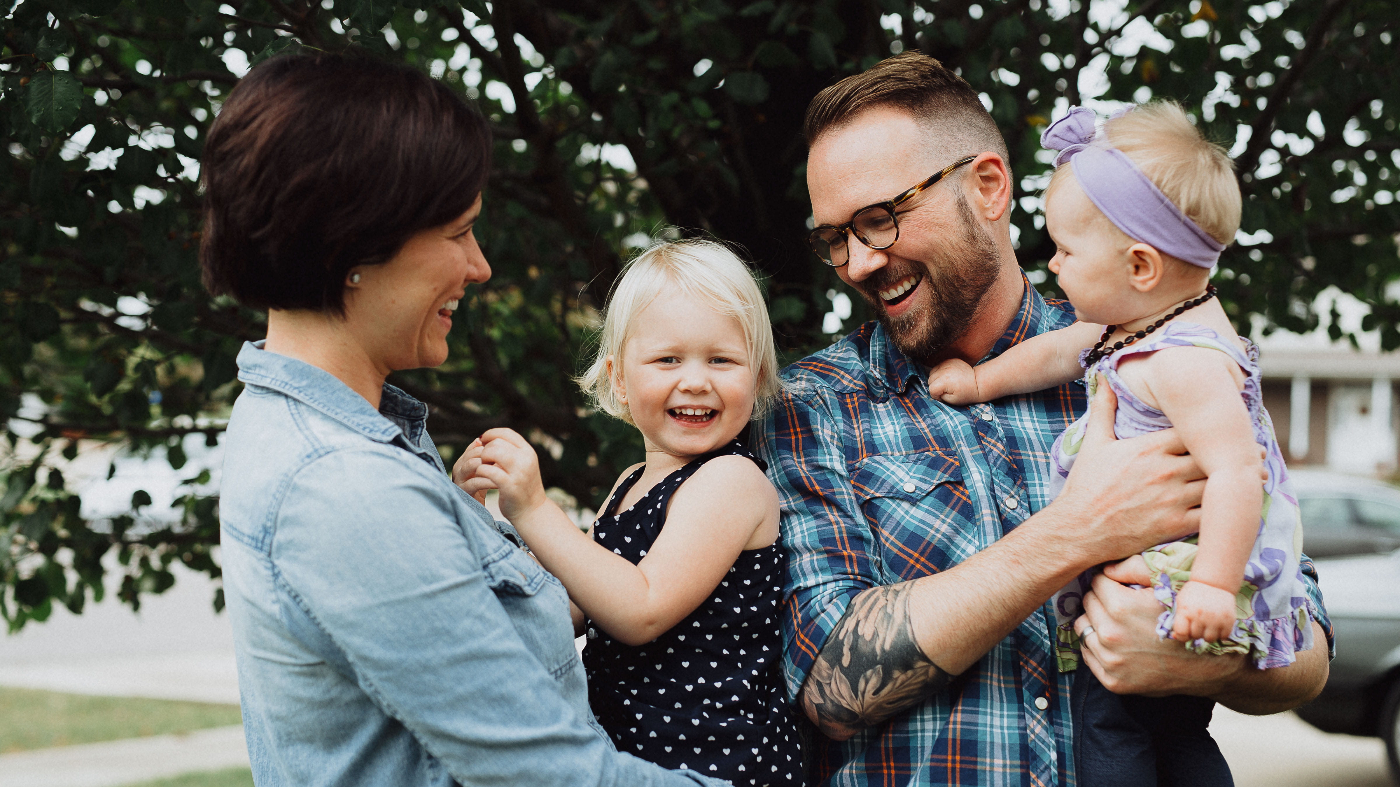 Man and Woman Holding Happy Child and Infant