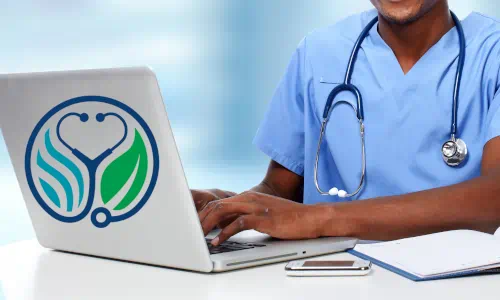 Healthcare professional using computer with environmental health education logo