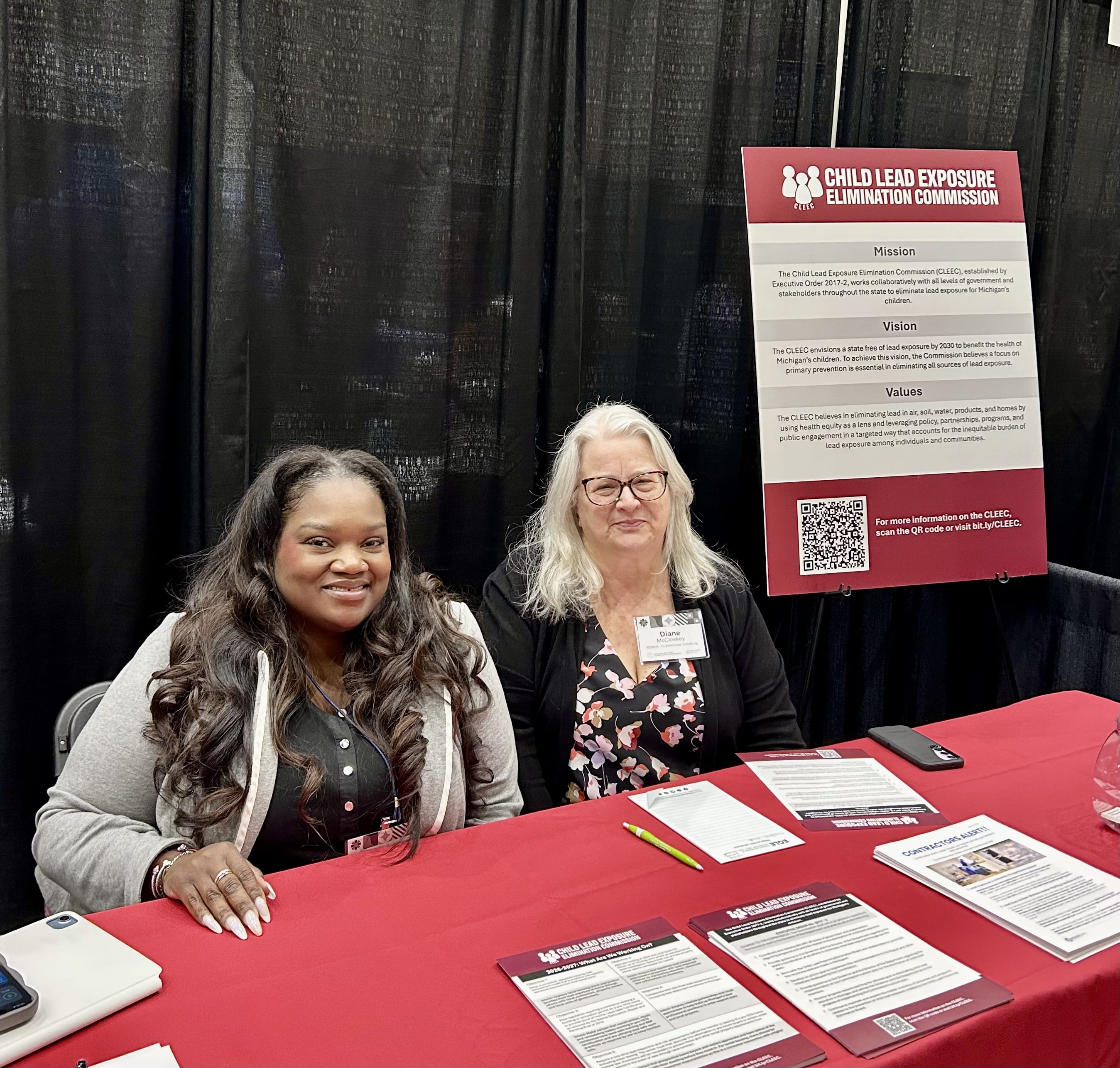 Jameela Maun and Diane McCloskey tabling tat the Building Michigan Communities conference on 5/12/26