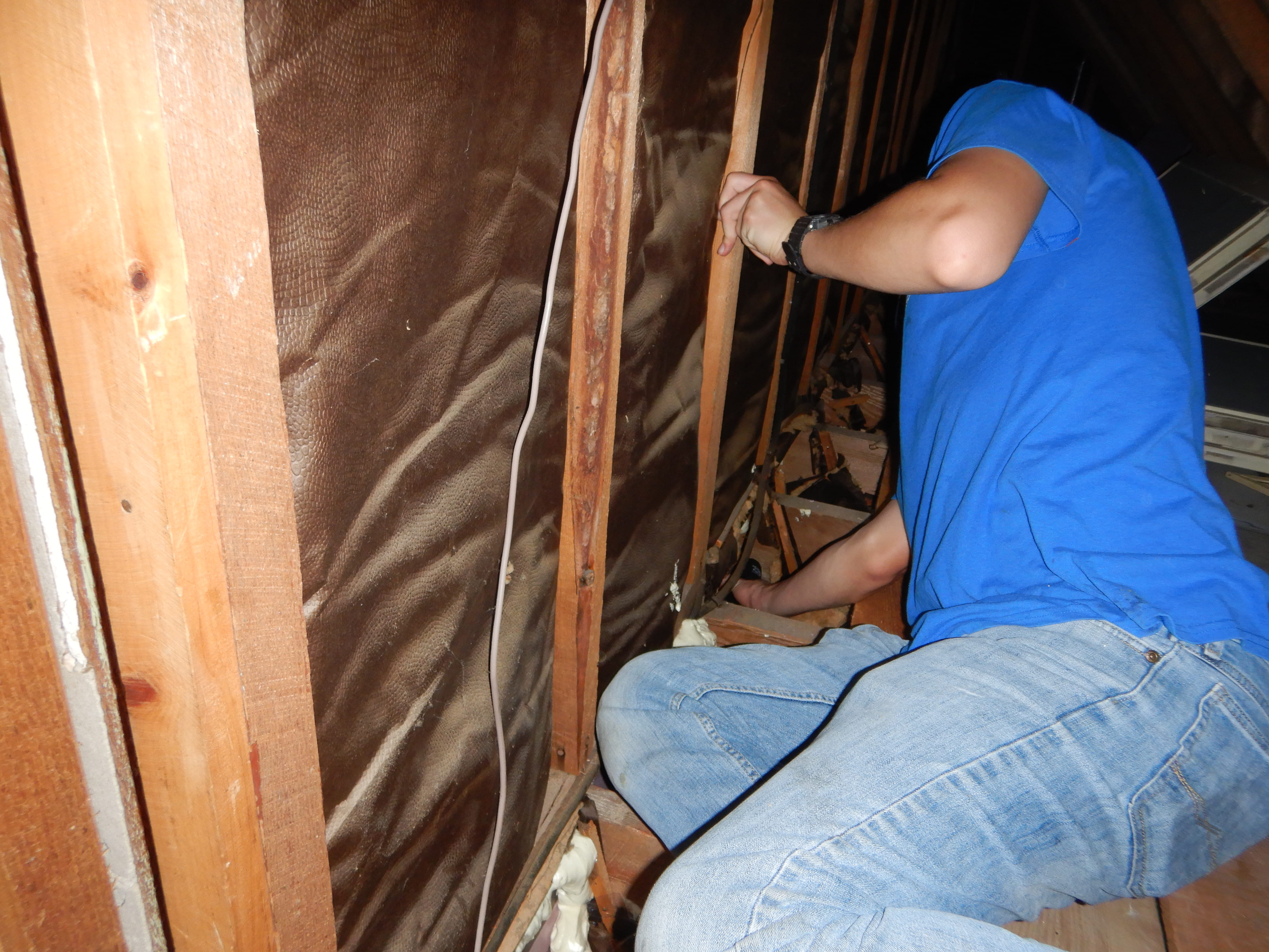 Contractor sealing an attic