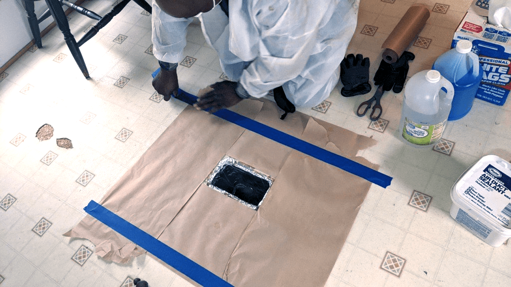 Weatherization worker prepping for duct sealing