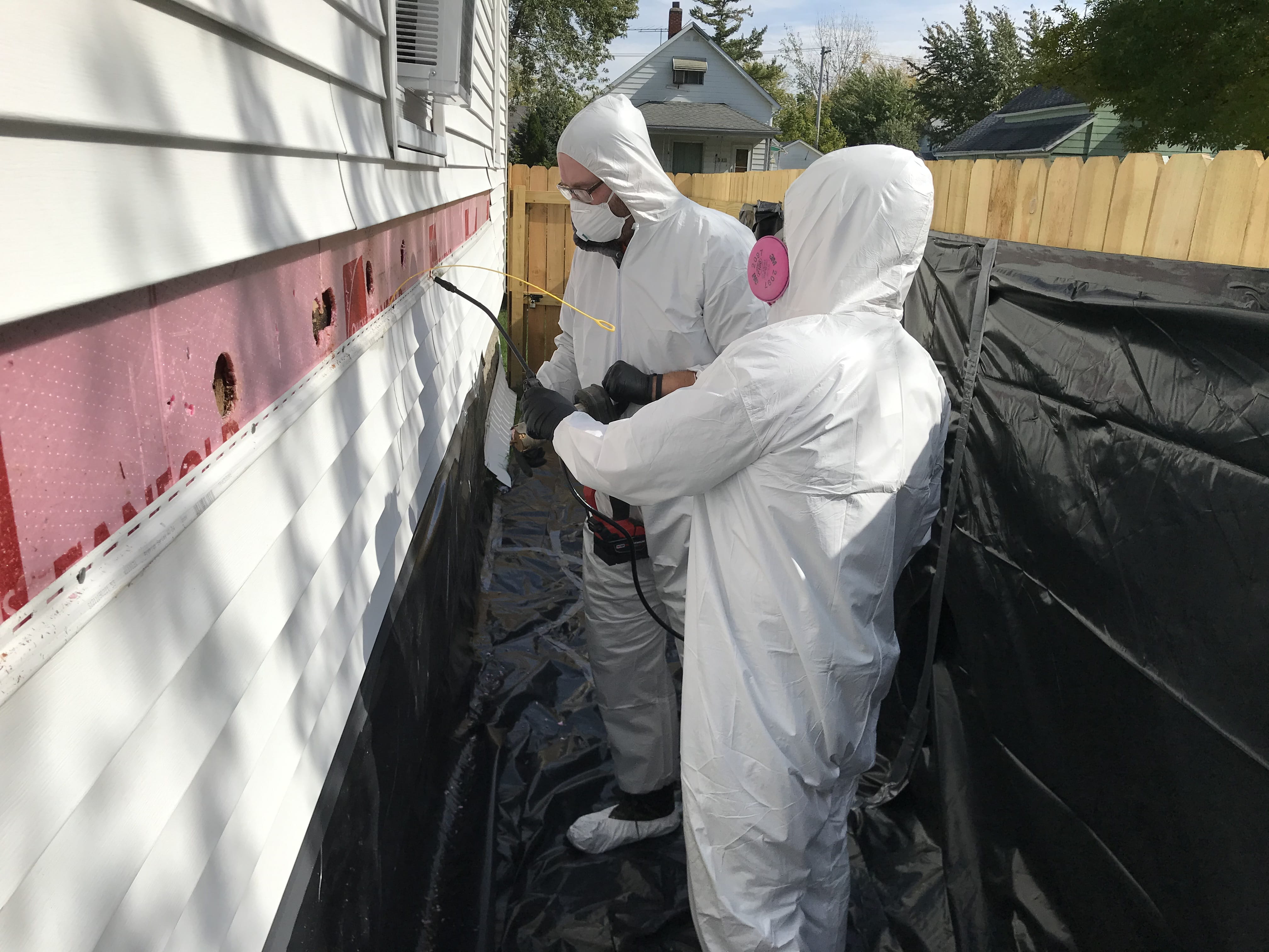 Weatherization workers demonstrating Lead Safe procedures