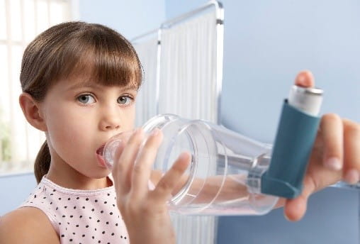 Girl using Asthma inhaler