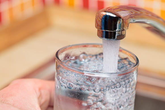 Glass being filled with tap water