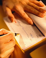 Person writing in a checkbook