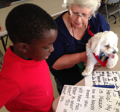 A student reading a letter from Maizie.