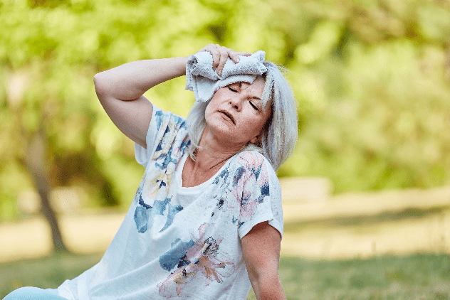 Woman suffering from heat illness