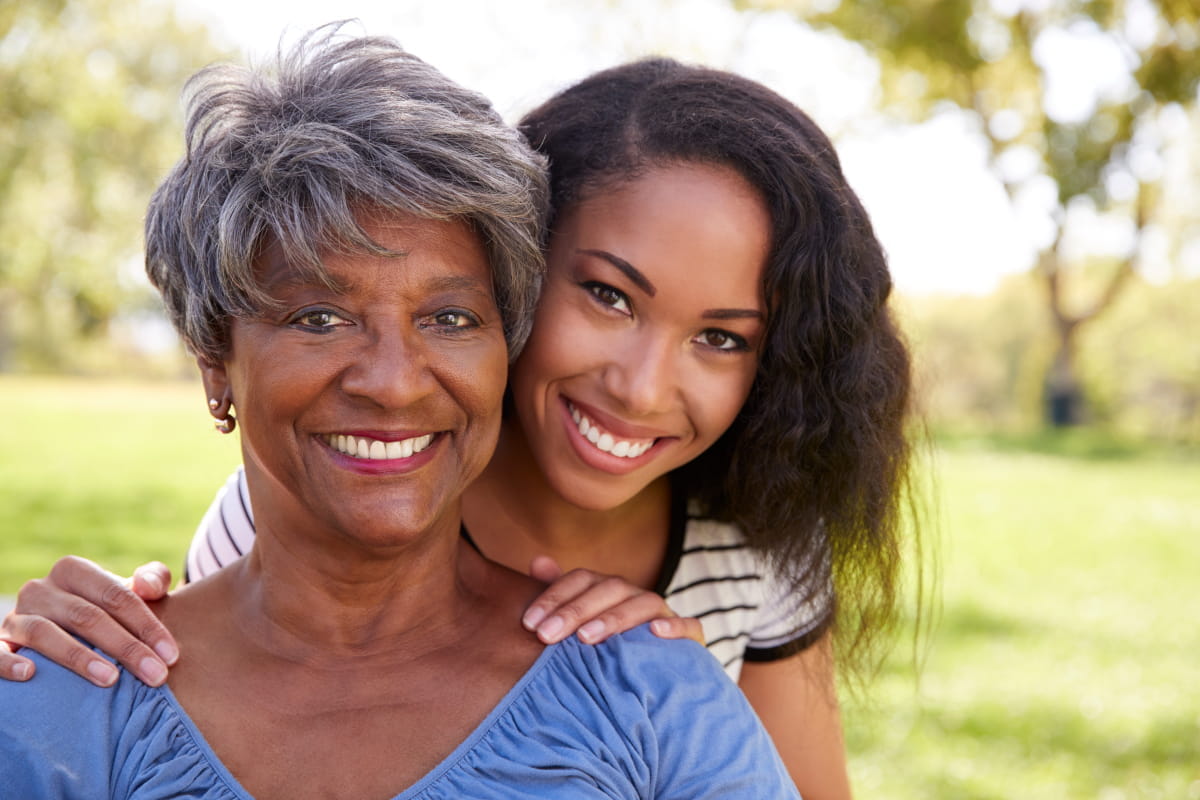 Senior African American/Black mother with daughter outside in park-like setting