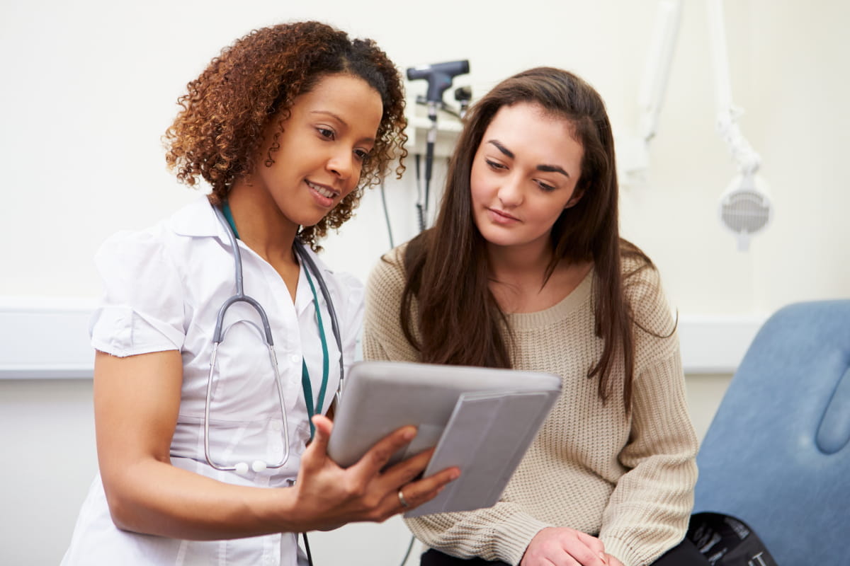 Medical staff person showing a patient their results