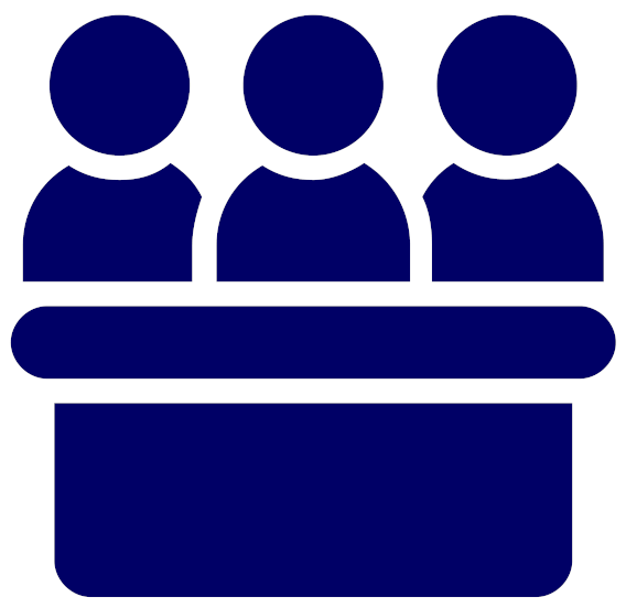 dark blue icon of three individuals sitting behind desk shown against a white background