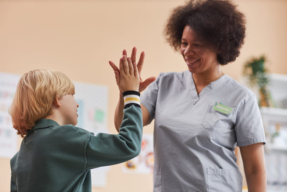 nurse high fives child