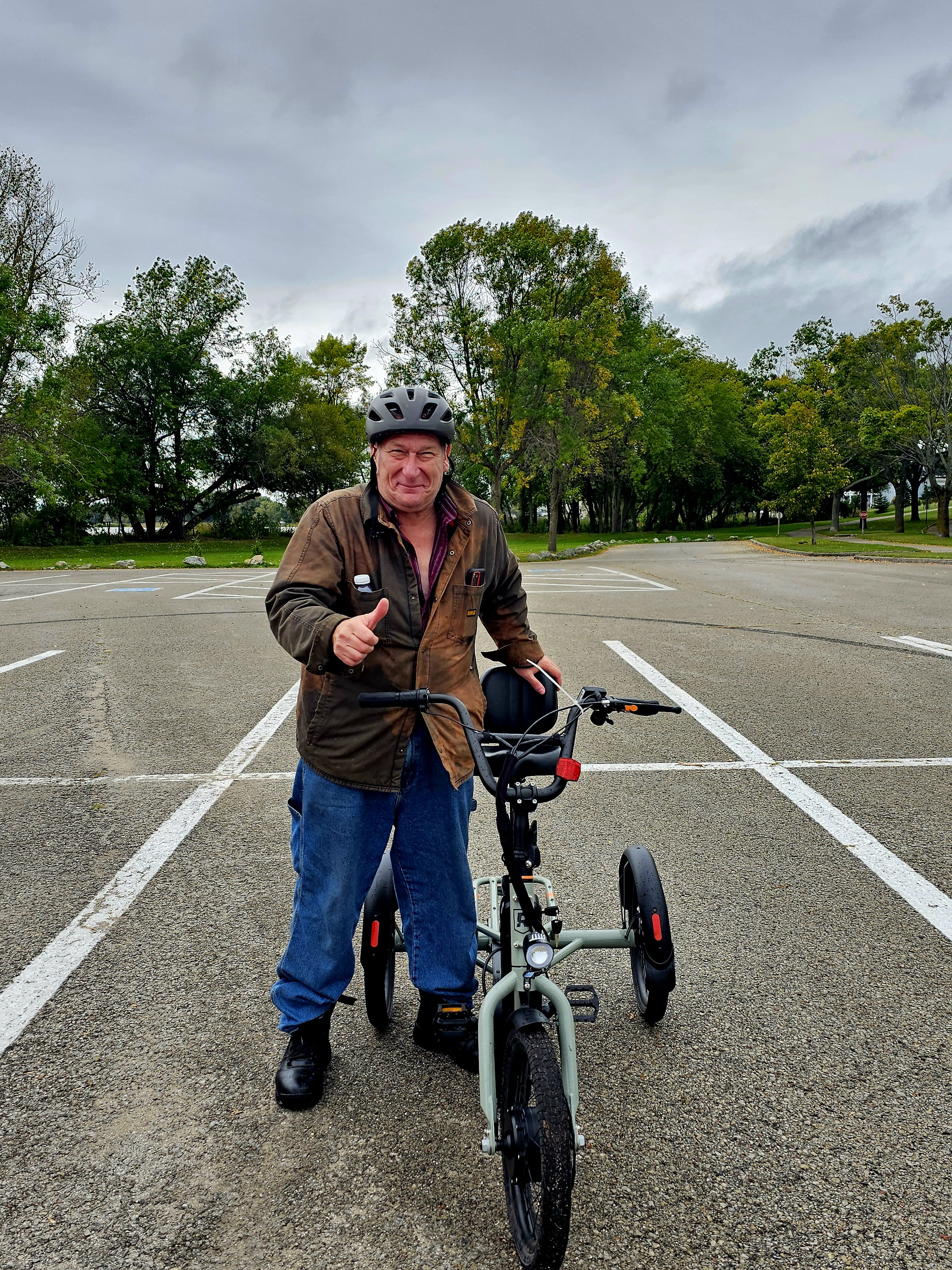 A photo of James standing with his e-trike