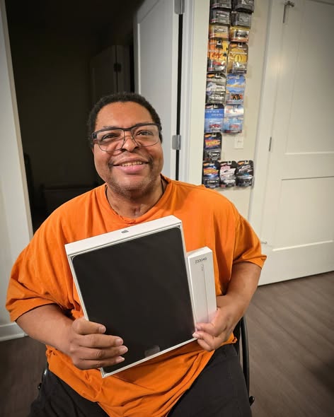 A photo of Tyrone holding his iPad Pro and Apple Pencil