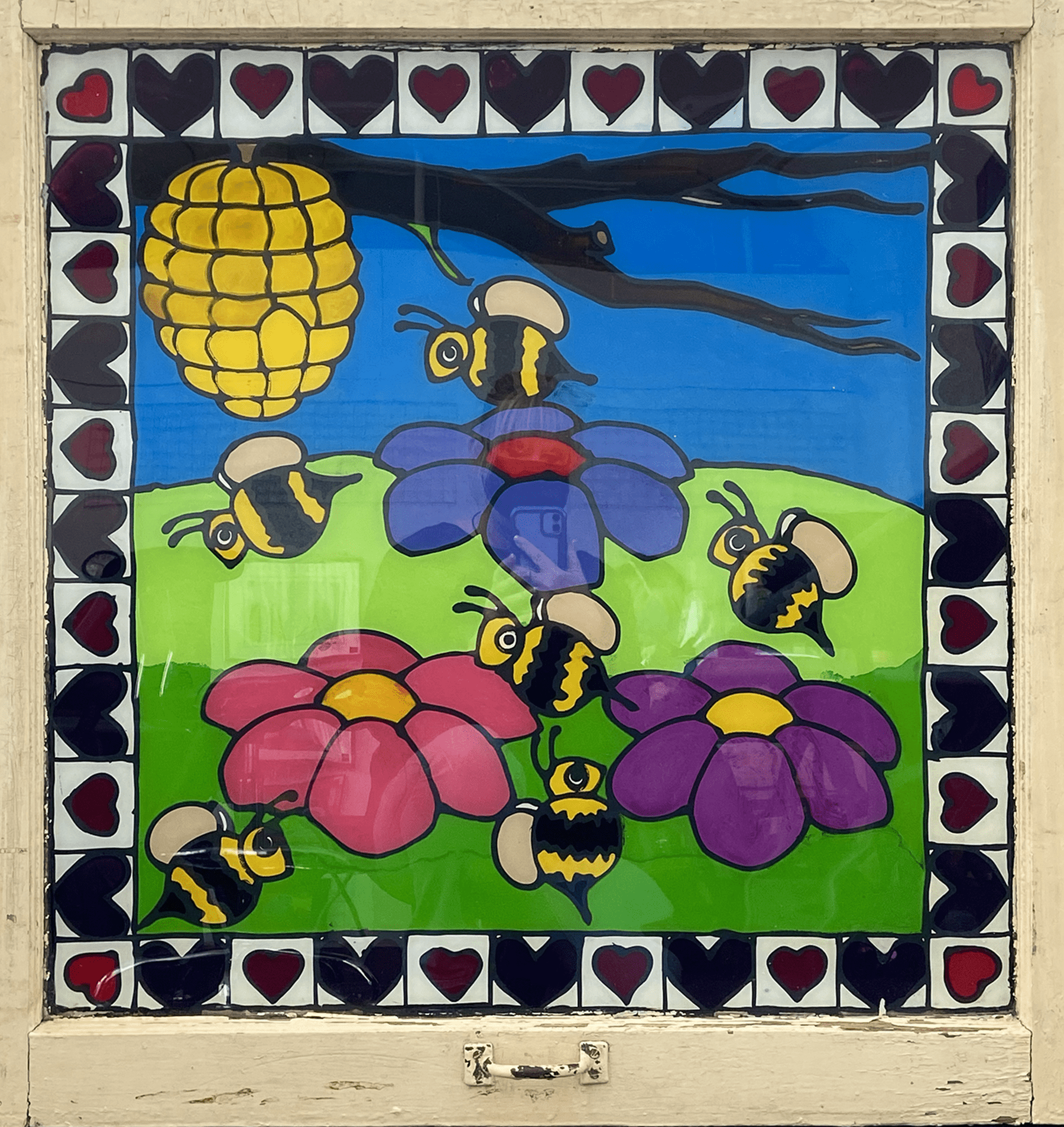 Artist: Rachael Kollman. Title of Artwork: Summer Bee Window. Artist Description: 32 x 32 inch recycled barn window adorned with acrylic inks.