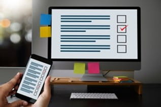 Computer and Cellphone displaying Checklist