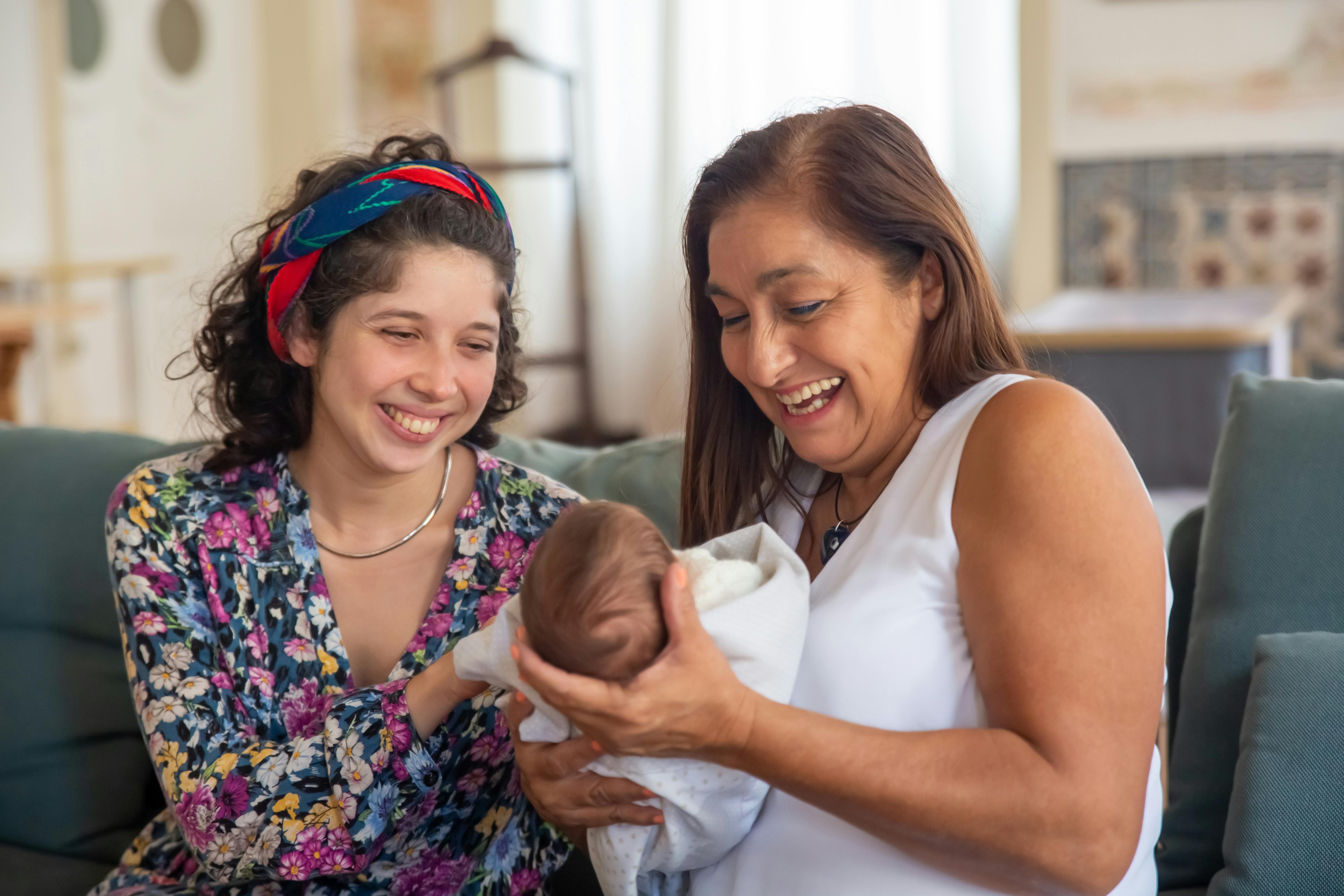 Two women holding an infant