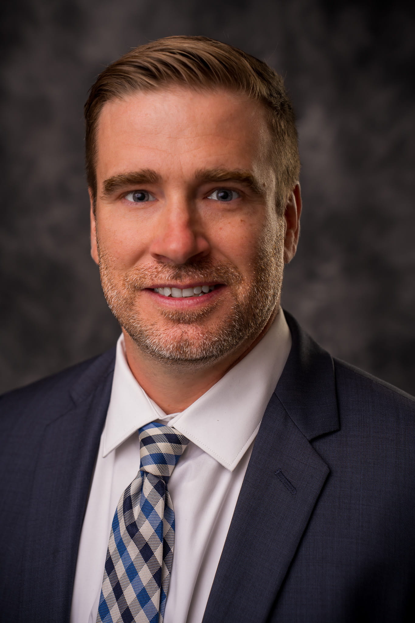 A photo of Nate Conley in front of a grey backdrop.