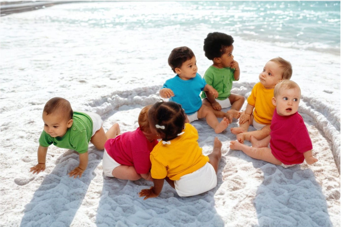 photo of babies playing on a beach