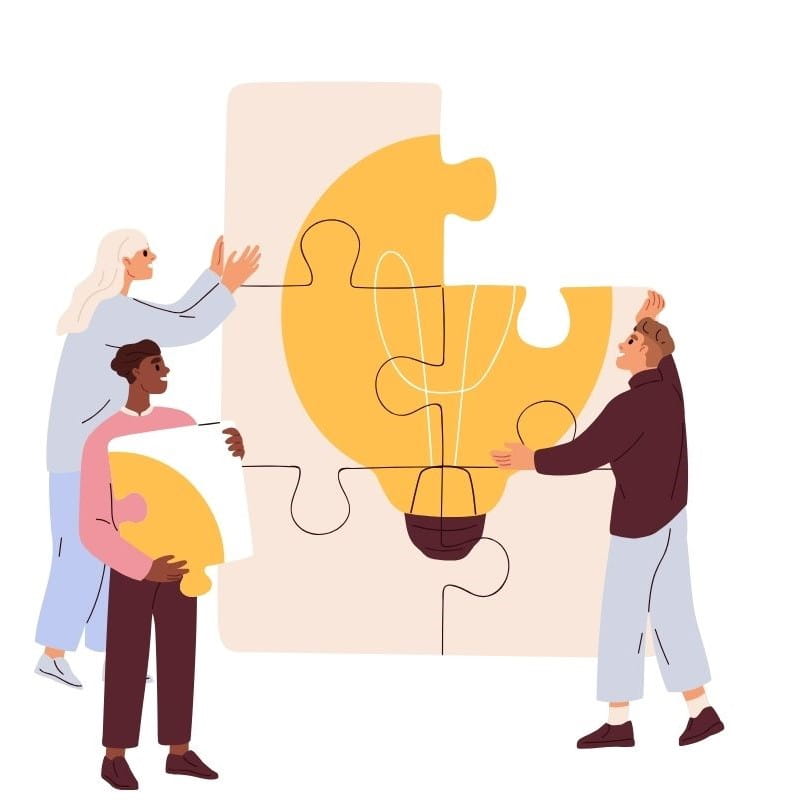 Three people working together to build a puzzle with a light bulb on it. 