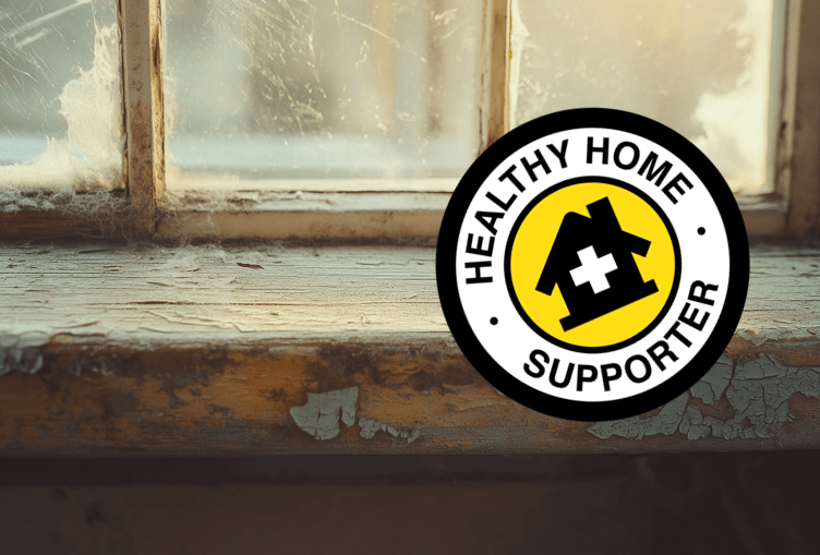 Cracked and peeling paint on a windowsill and healthy home supporter badge