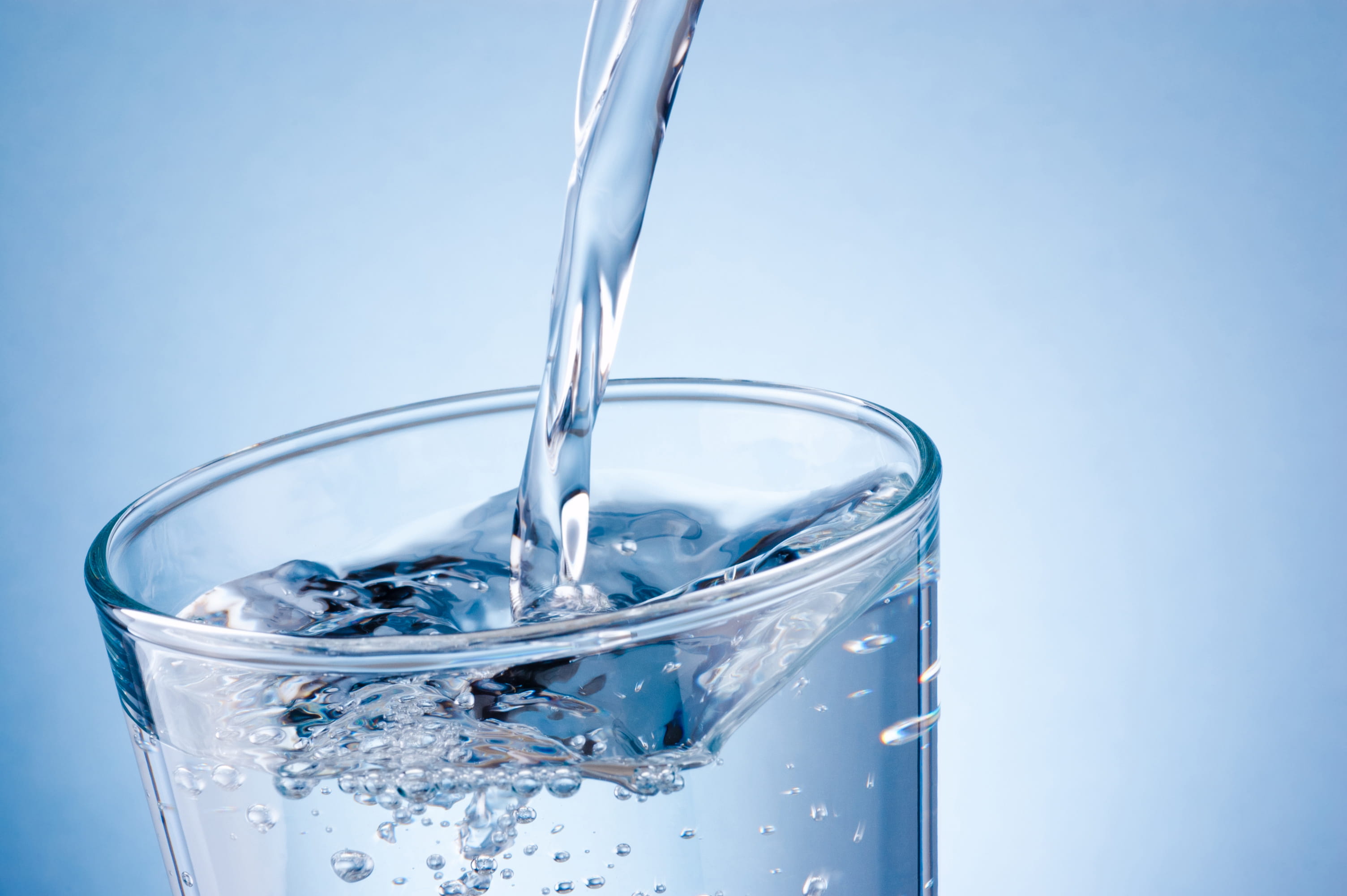 Drinking glass filling with water