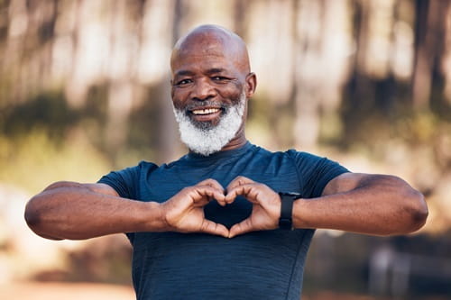 Man holding his hands in a heart shape
