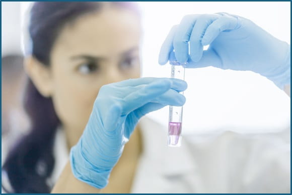 Scientist looking at a test tube