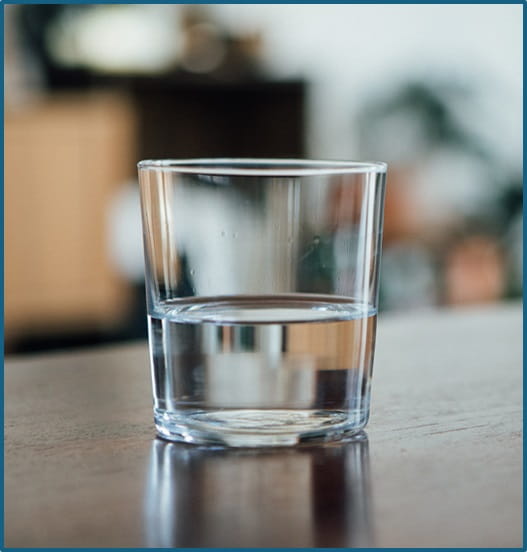Glass of water sitting on a table