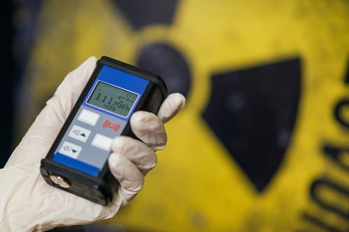 Geiger counter with radiation symbol in background