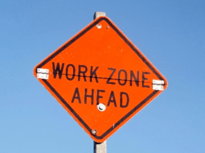 Sign reading "work zone ahead"