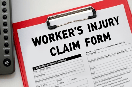 Workers injury claim form on clipboard