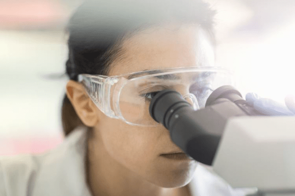Scientist looking in a microscope