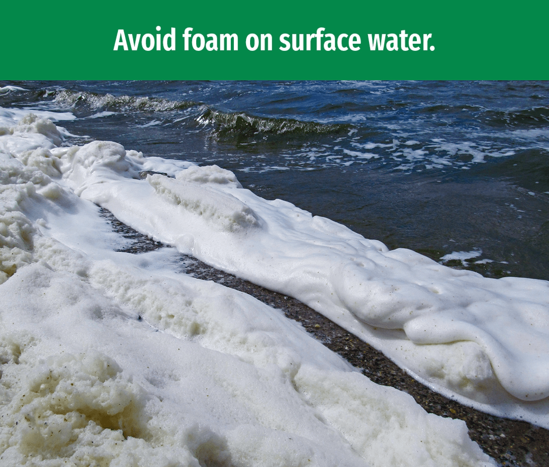 Foam washing up on a shoreline. Text reads Avoid foam on surface water.