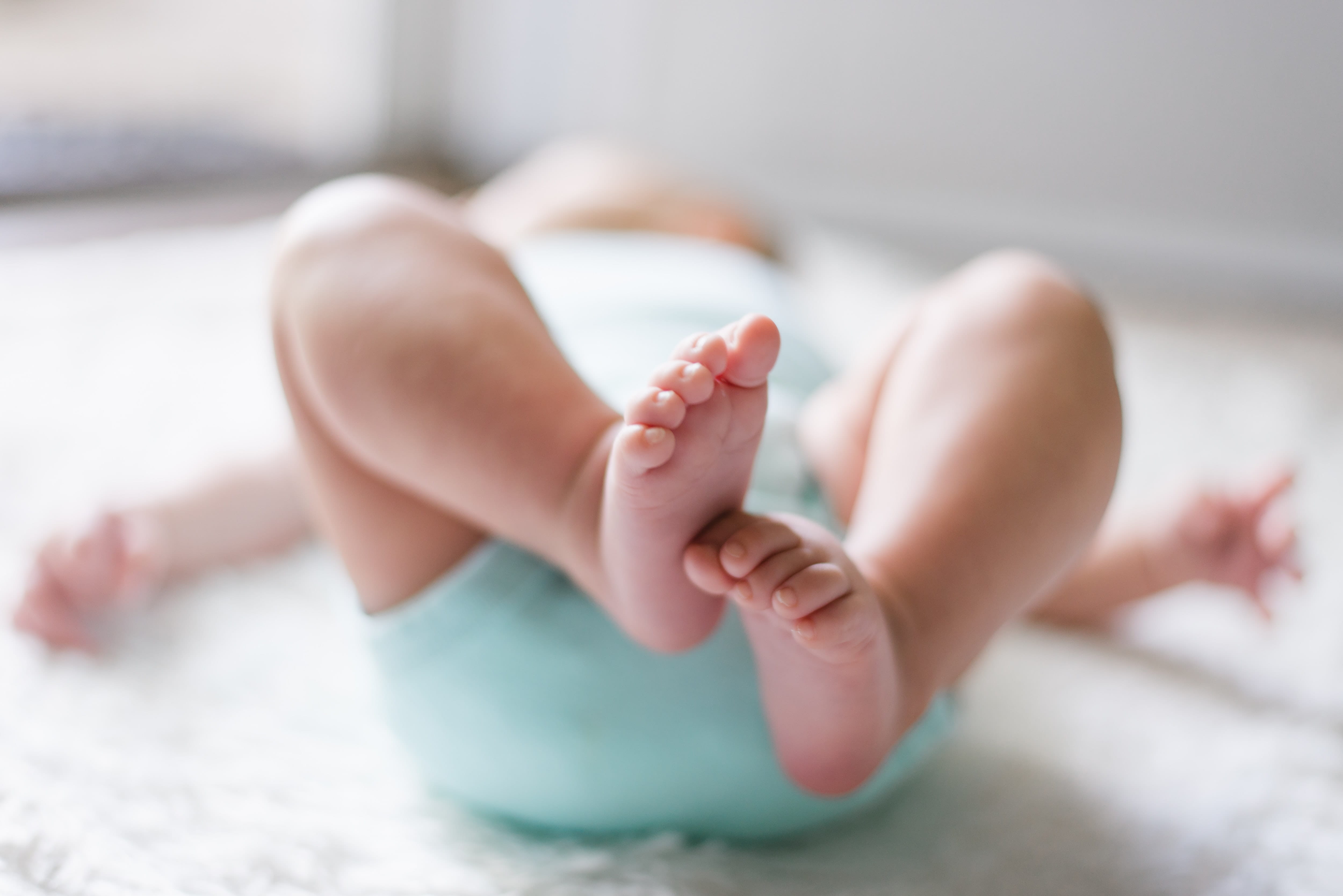 Photo of a baby laying on a blanket