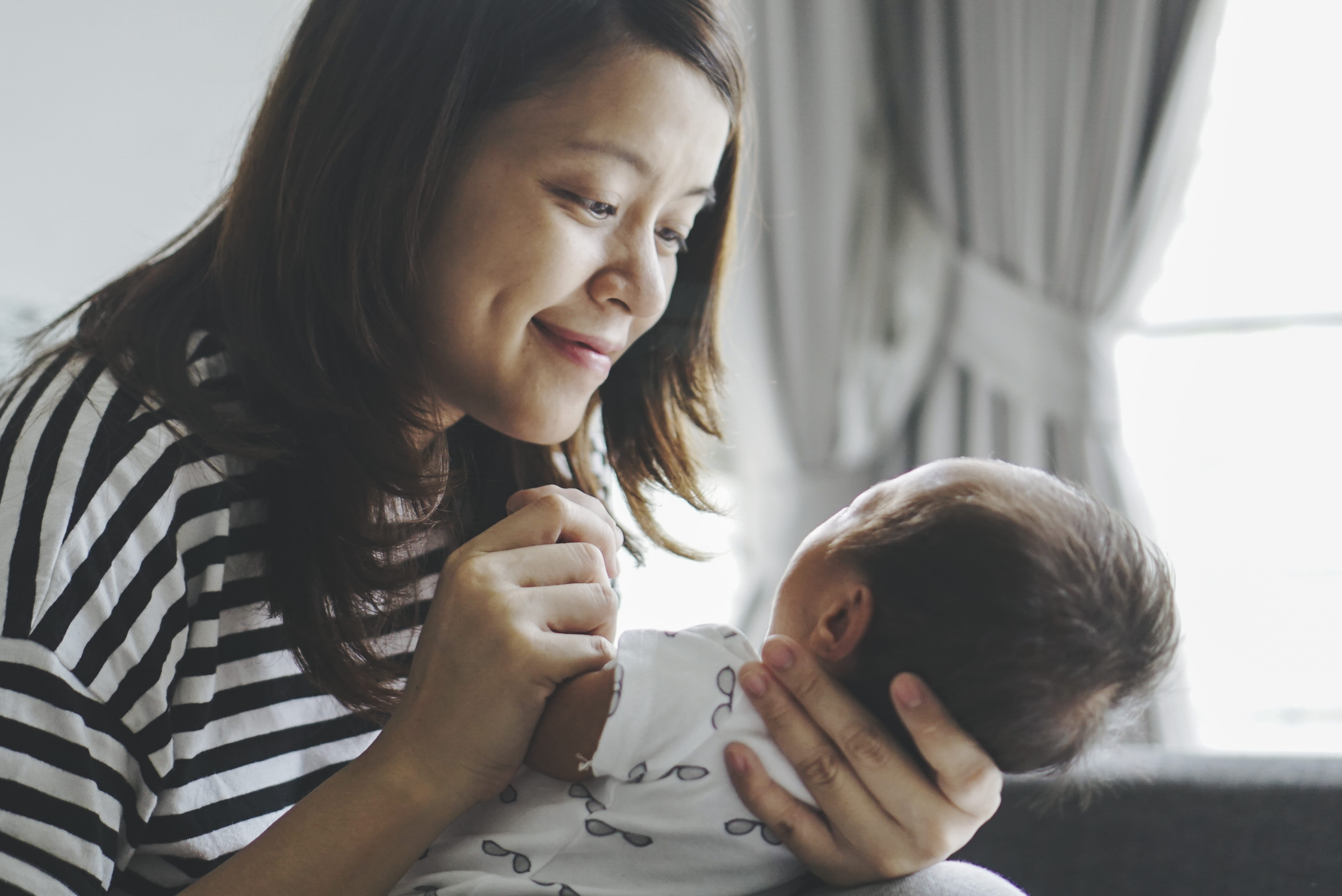 Woman smiling at baby she is holding