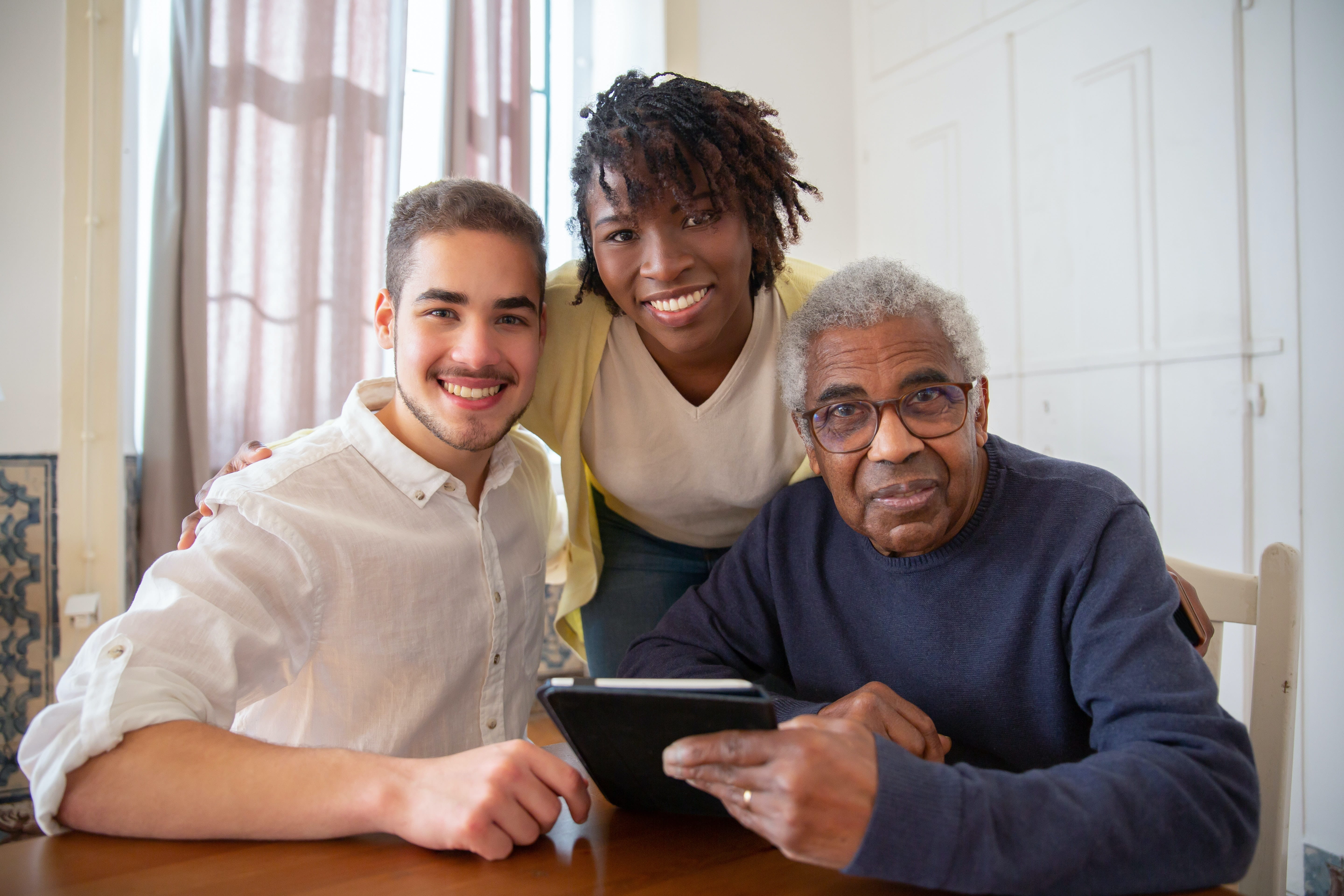 Three people smiling at the camera