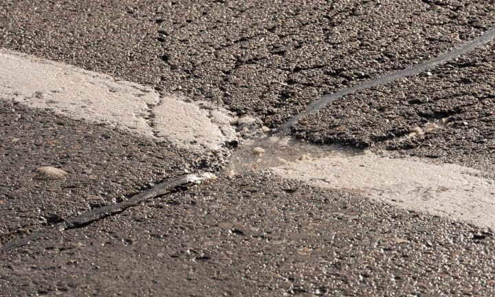A pothole on a state trunkline filled with ice.