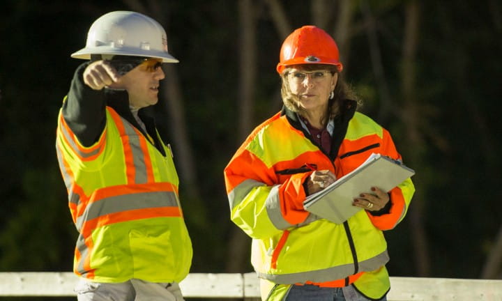 Staff work with a woman construction business owner.