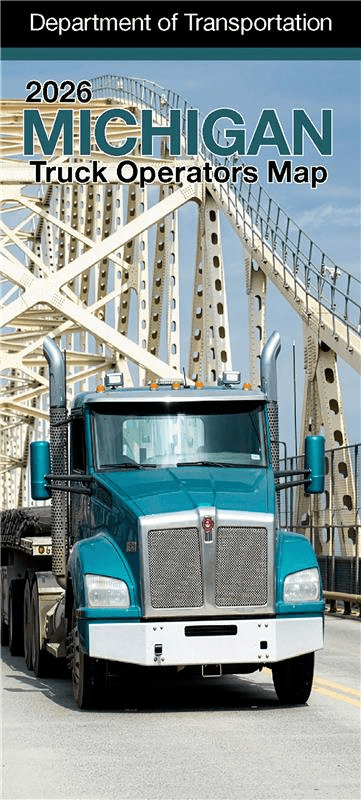 The cover of the Michigan Truck Operators Map showing a semi truck on a Michigan freeway at sunrise.